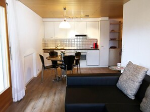 A compact living space with a kitchenette, dining area, and seating area.