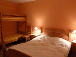 A bunk bed room with a single bed, a nightstand with a lamp, and a chair. - Chalet for 12 in the heart of ArÃªches-Beaufort (Arêches-Beaufort)