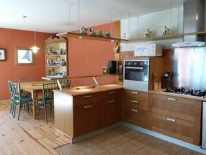 A kitchen with wooden cabinets, a built-in oven, a microwave, and a gas stove. - Chalet for 12 in the heart of ArÃªches-Beaufort (Arêches-Beaufort)