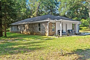 A single-story house with a brick exterior and a covered porch.