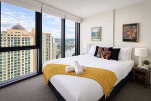 A hotel room with a large bed, a view of the cityscape, and a Marriott hotel building in the background. - Sky-high Haven-rooftop Infinity Pool Parking Wifi (Brisbane)