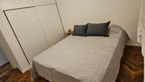 A bedroom with a bed, a ceiling fan, and a wardrobe. - Comfortable and Well-Located in Recoleta (Buenos Aires)