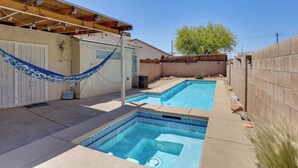A residential backyard with two swimming pools, a hammock, and a wooden deck. - Private Pool & Spa: North Las Vegas Retreat! (North Las Vegas)