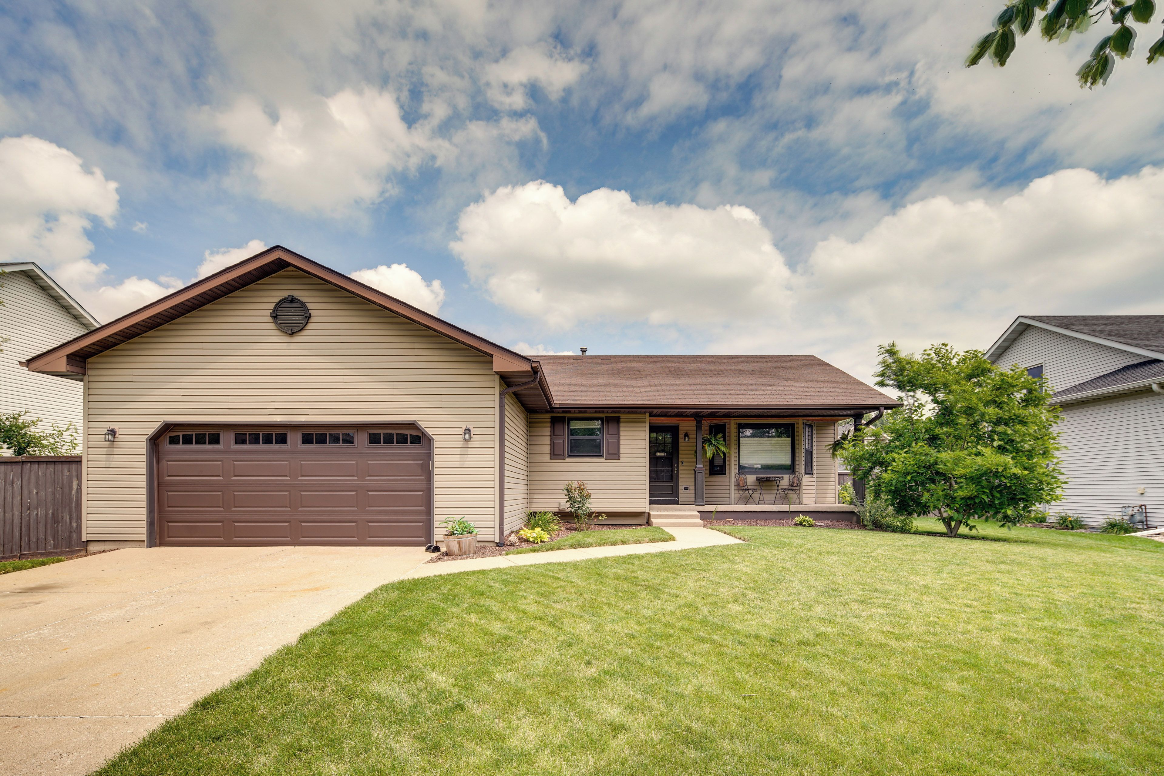 A single-story house with a garage, a front porch, and a well-maintained lawn.
