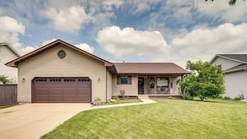 A single-story house with a garage, a front porch, and a well-maintained lawn.