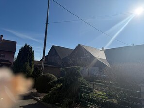 A residential area with houses, a clear sky, and a street.