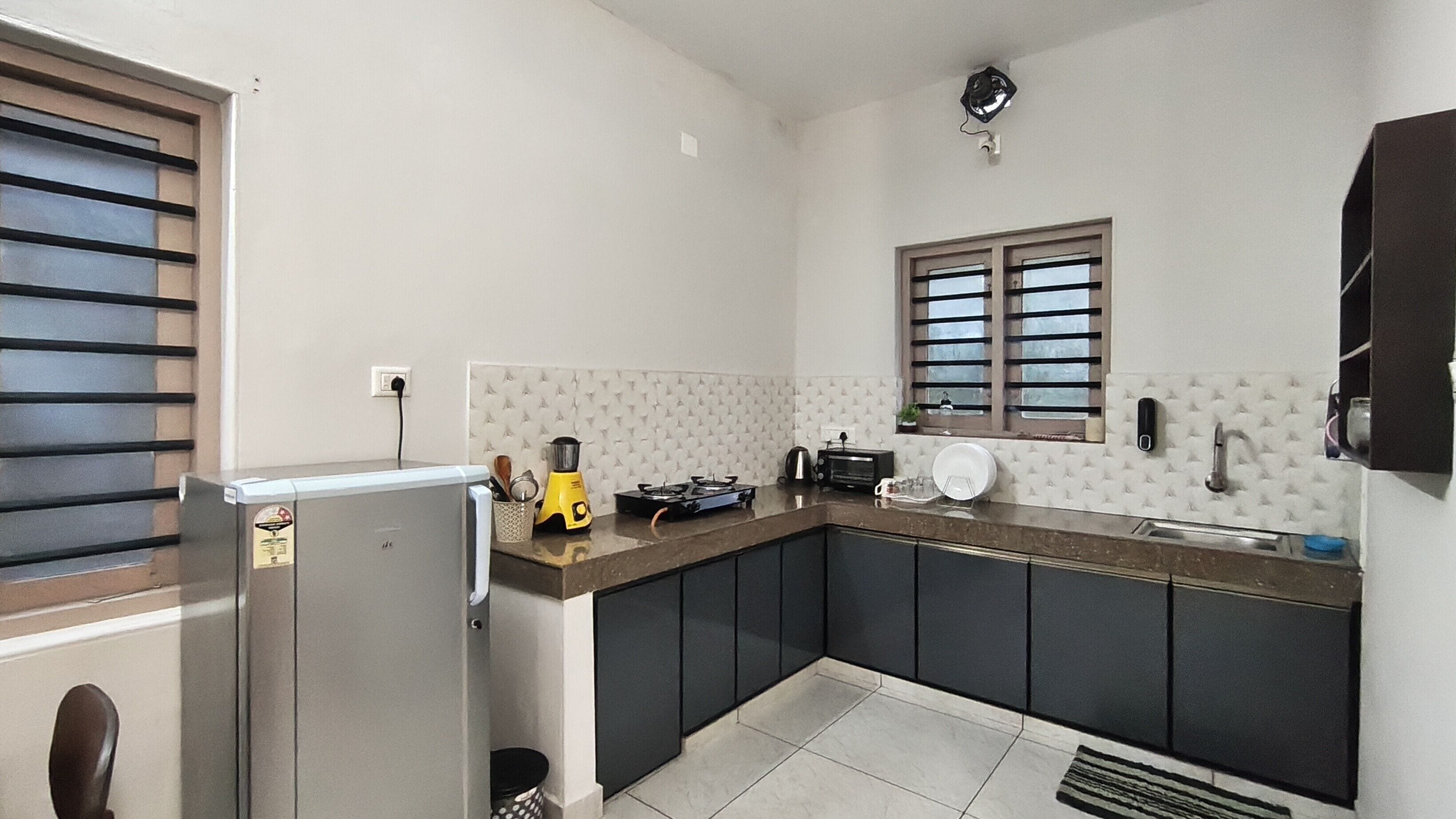 A compact kitchen with a refrigerator, stove, and sink.