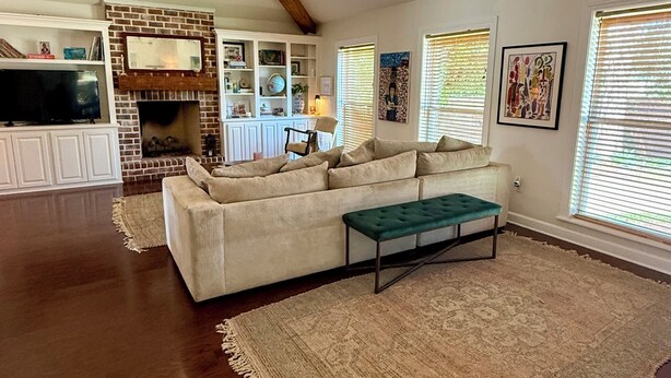 A spacious living room with a fireplace, a ceiling fan, and a large rug. - Oxford at its Best! Location, Layout, Privacy!! (Oxford)