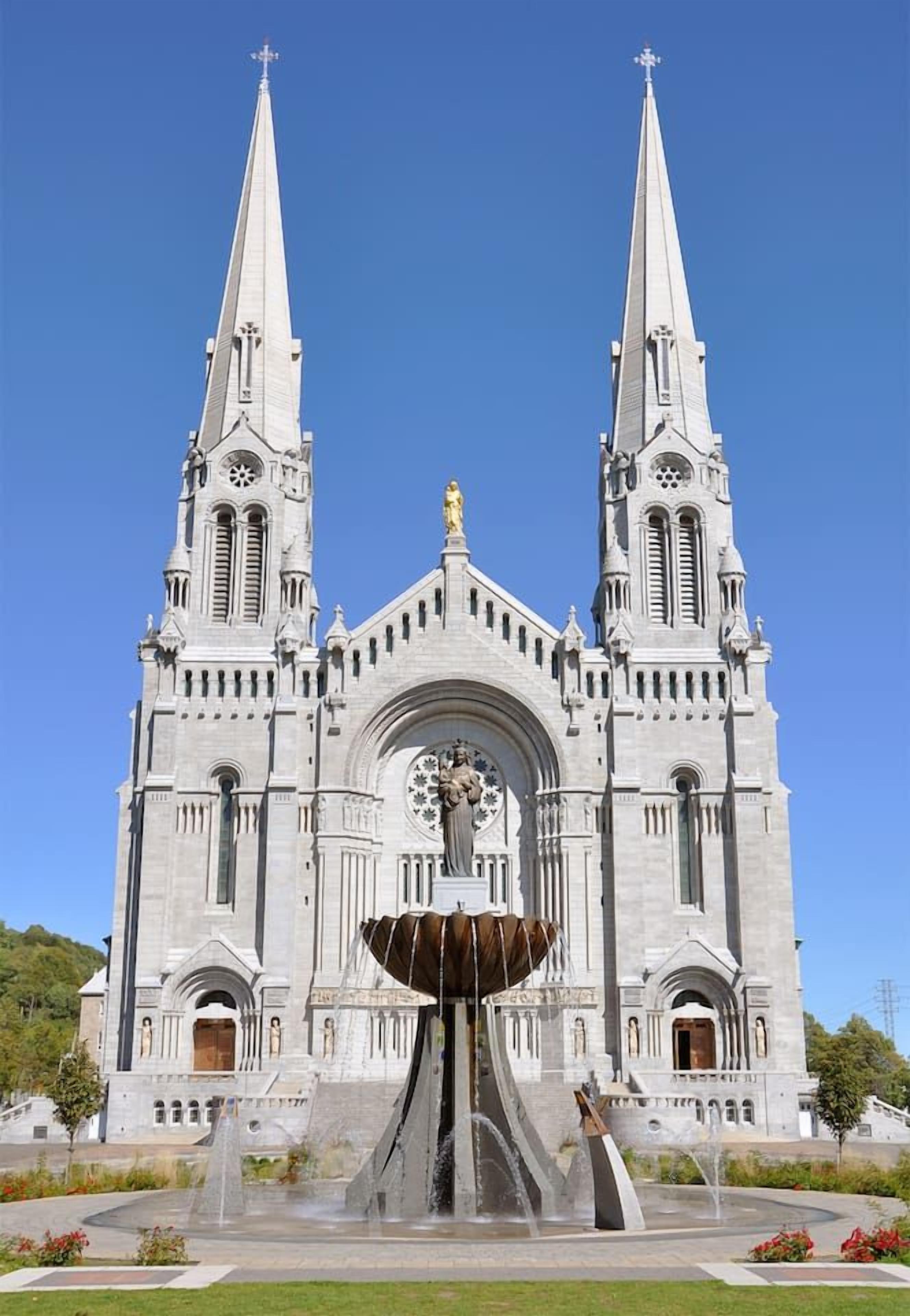 A large cathedral with twin spires and a central fountain.