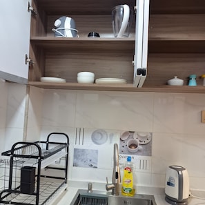 A kitchen with a built-in dishwasher, a coffee maker, and a sink. - Beautiful 1-bedroom bed & breakfast in terrific Nairobi location (Nairobi)