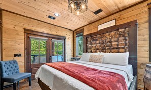 Ein Schlafzimmer mit Holzwänden, einem Bett, einer Bank und einem Schild mit der Aufschrift 'lets snuggle'.