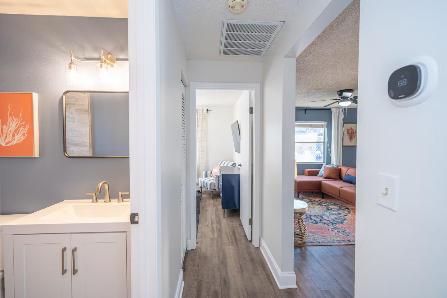 A hallway leading to a living area with a sofa and a coffee table.