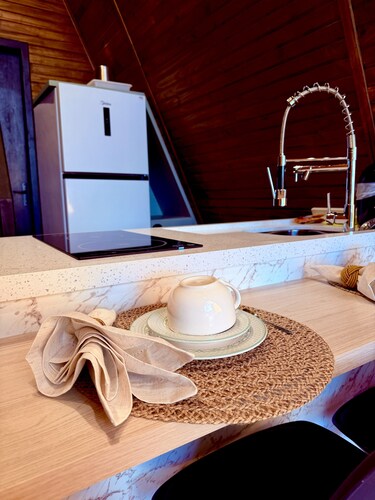 Woodland cabin with hot tub surrounded by nature.