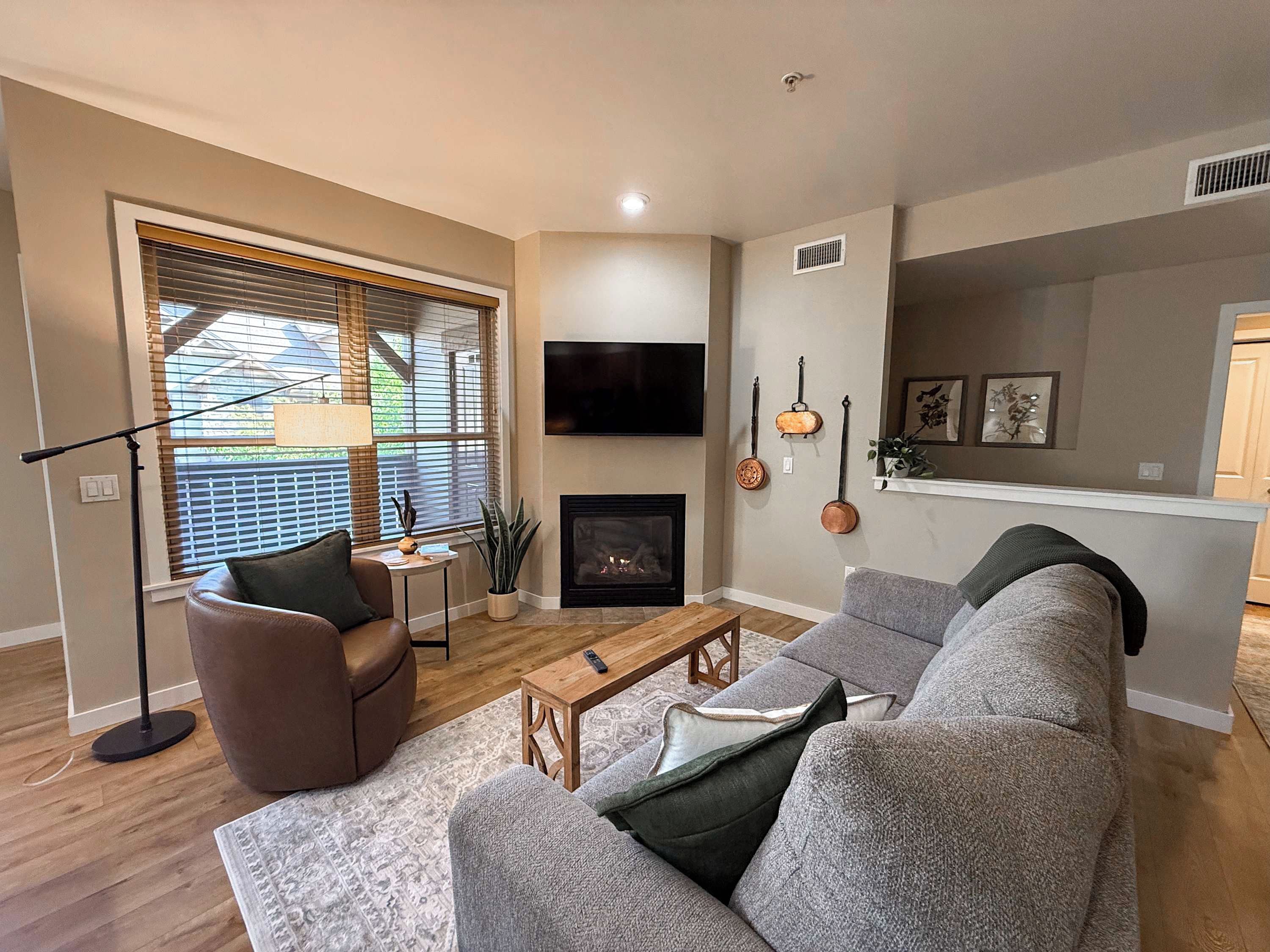 Una sala de estar con chimenea, televisor y sofá.