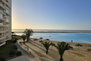 A beachfront property with a pool, palm trees, and a view of the sea. - Peace, Sea and Space to Enjoy Laguna del Mar (La Serena)