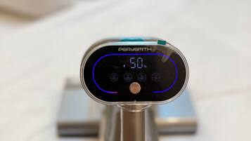 A Persimath device on a metallic stand with a digital display indicating 60%.