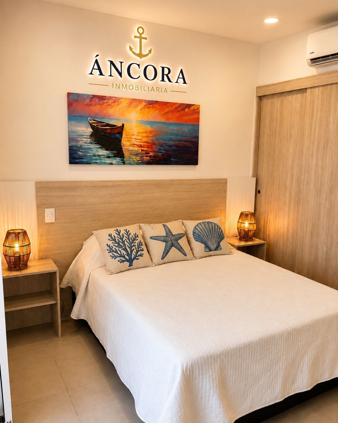 A bedroom with a bed, a nightstand, a wall-mounted air conditioner, and a painting of a boat on the wall.