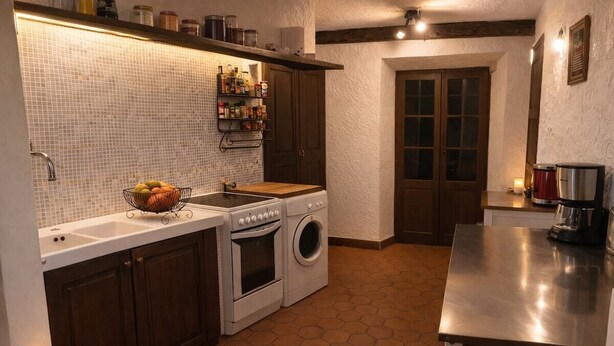 A kitchen with a tiled backsplash, wooden cabinets, a sink, a stove, a washing machine, and a countertop with a coffee maker.