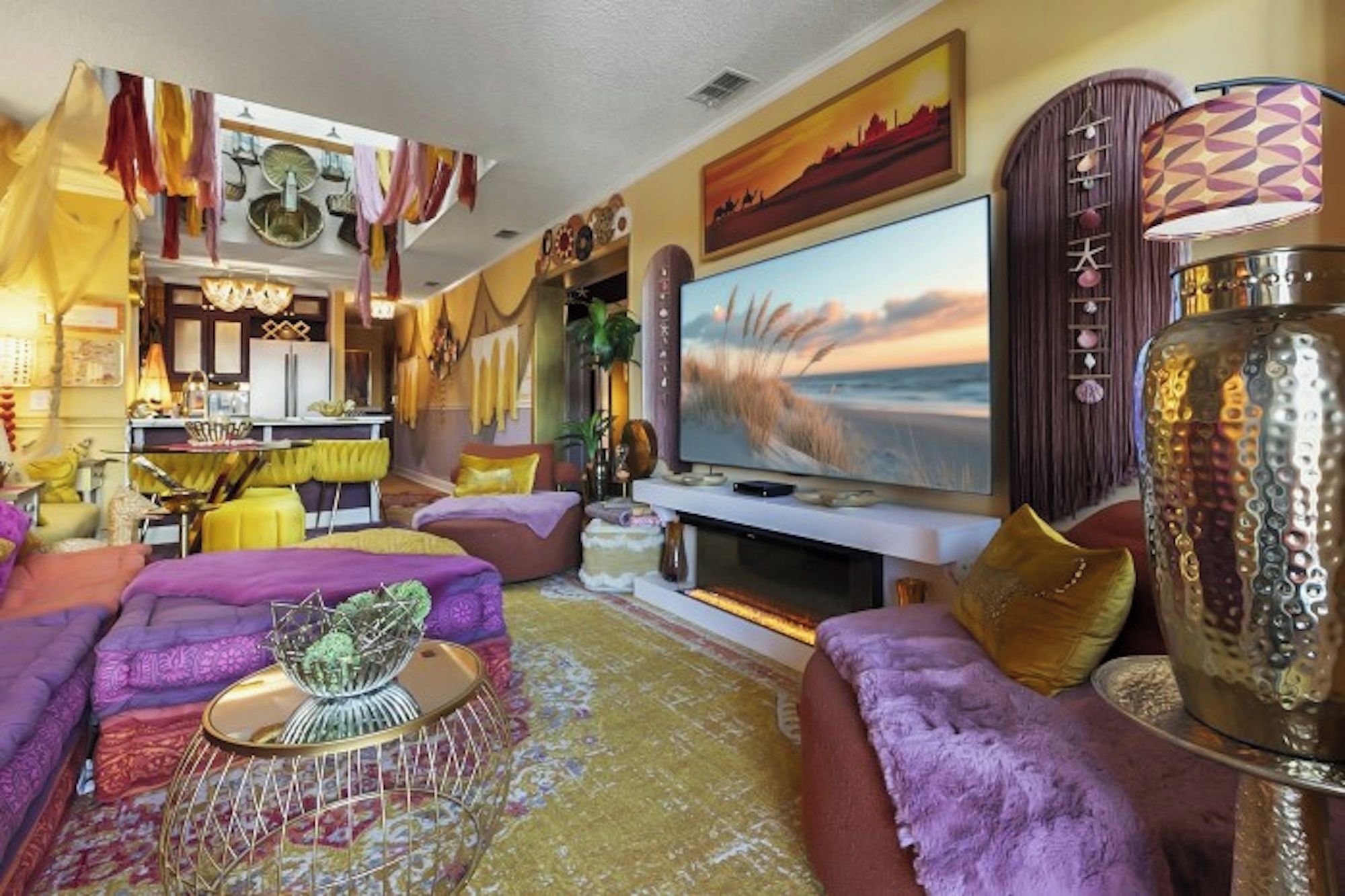 A living room with a large flat-screen TV, a sofa set, a coffee table, and a decorative cabinet.