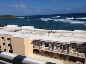 A rooftop with air conditioning units, a balcony with a pergola, and a view of the ocean. - 3-bedroom Ocean Front Villa, Dawn Beach Club at JW Marriott. Fixed 6403 (oyster pond)