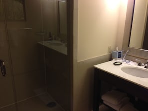 A bathroom with a glass-enclosed shower, a sink, and a mirror. - 3-bedroom Ocean Front Villa, Dawn Beach Club at JW Marriott. Fixed 6403 (oyster pond)