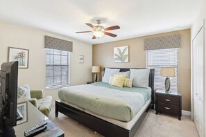 A bedroom with a bed, bedside tables, a ceiling fan, and a TV. - Upstay Luxury Family Home with Pool & Cinema ChampionsGate (Davenport)