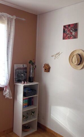 A room with a bookshelf, a wall-mounted birdhouse, a framed picture, and a decorative wall hanging. - Villa for 6–8 people in the heart of the Provençal Baronnies, with activities for every season (Ribeyret)