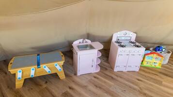 A play kitchen set with a sink, stove, and toy house.