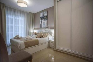 A modern hotel room with a bed, bedside table, and a large window. - Brisamarina House, Ivan Luxury Homes, 2nd Floor, South, First Row (Oropesa del Mar)