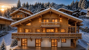 A multi-story wooden chalet with balconies, large windows, and a snow-covered landscape. - SIGA Grand BO Chalet, Sleeps 14–16 — Newly Built and Fully Equipped (Le Grand-Bornand)