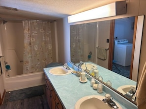 A bathroom with two sinks, a shower, and a large mirror. - Happy Homeplace - 1-bedroom farmhouse with AC in charming Bedford (Bedford)