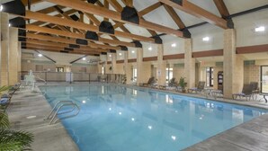 An indoor swimming pool with clear water, wooden beams, and lounge chairs. - Cozy 1-bedroom condo in beautiful West Yellowstone with AC (West Yellowstone)