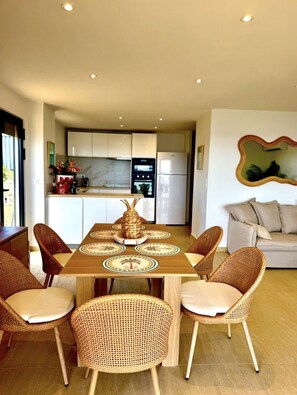 A modern kitchen with white cabinets, a built-in oven, and a refrigerator. - SEA VIEW TINTAMARRE Villa – Brand-new waterfront villa in Oyster Pond (Oyster Pond)