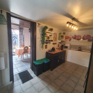 A compact kitchen with a dining area, a coffee station, and a tiled floor. - Your own farmfouse (Béalencourt)