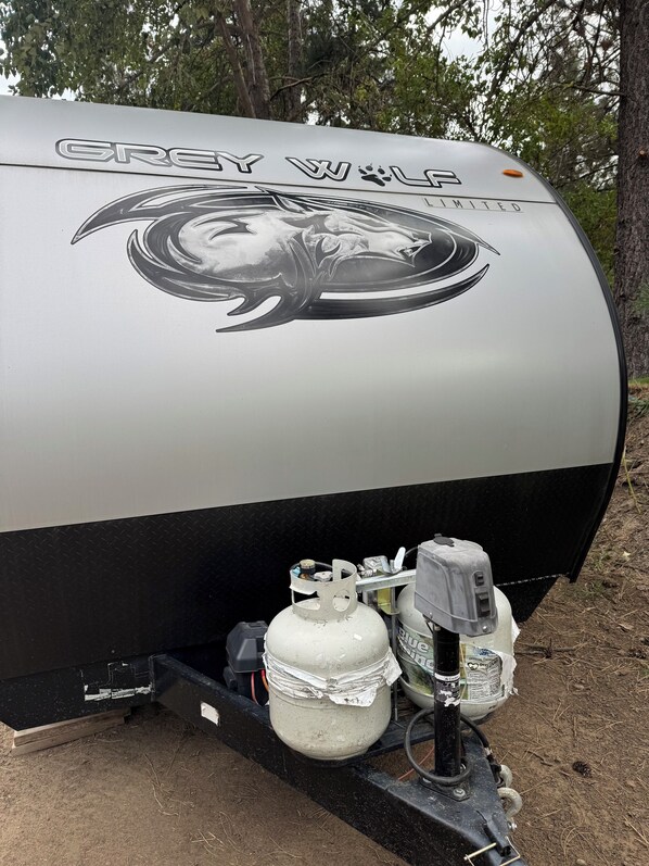 A Grey Wolf Limited propane tank with a metal frame and two propane cylinders.
