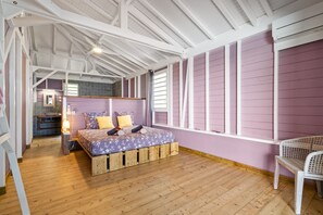 A room with a bed, a wooden floor, a window, and a chair. - Villa Coco Prestige - Three Bedroom Villa, Sleeps 6 (Les Trois-Îlets)