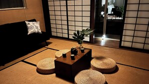 A tatami mat room with a low table, cushions, and a plant. - Japanese garden estate in Monterey Count on a 40 acre ranch (Salinas)