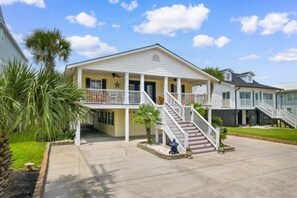 A two-story house with a balcony, a staircase, and a front porch. - The Gatsby House - Ocean View - Steps to Beach - 8BR 6BA (Murrells Inlet)