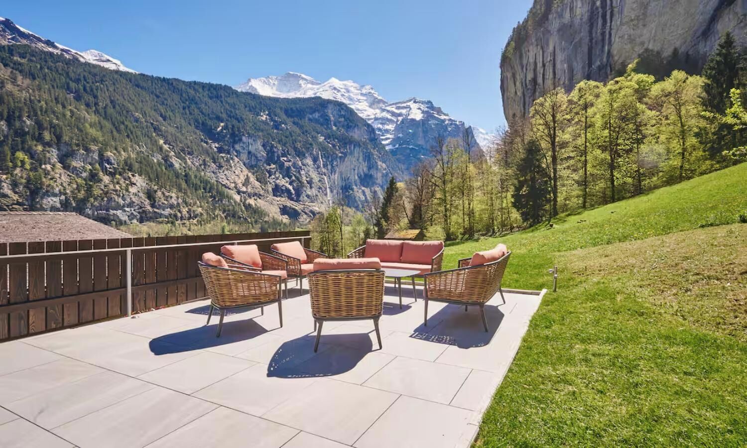 A patio with outdoor furniture and a mountain view.