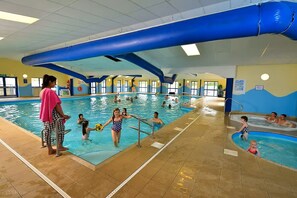 An indoor swimming pool with multiple lanes, a lifeguard stand, and a separate toddler pool area. - Sandy Toes New 2026 Stylish 2Bed Steps from Beach (Challaborough)