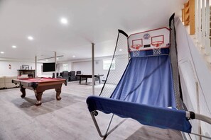 A room with a pool table, a ping pong table, and a basketball hoop. - Ultimate Pocono Getaway  HotTub•Theater•GameRoom (Tunkhannock Township)