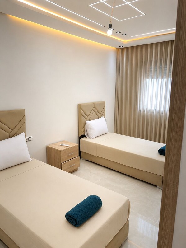 A hotel room with two beds, a nightstand, and a modern ceiling design.