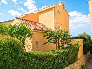 A building with a sloped roof, a stone wall, and a clear sky. - Unique villa right on the beach with its own dock. Completely renovated, Zadar (Bibinje)