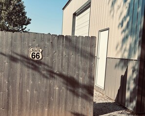 A wooden fence with a Route 66 sign.