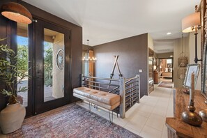 A modern interior with a bench, a mirror, and a staircase. - Cougar Cañon Ranch, Colorado Mountain Retreat - Incredible Views and Amenities (Cañon City)