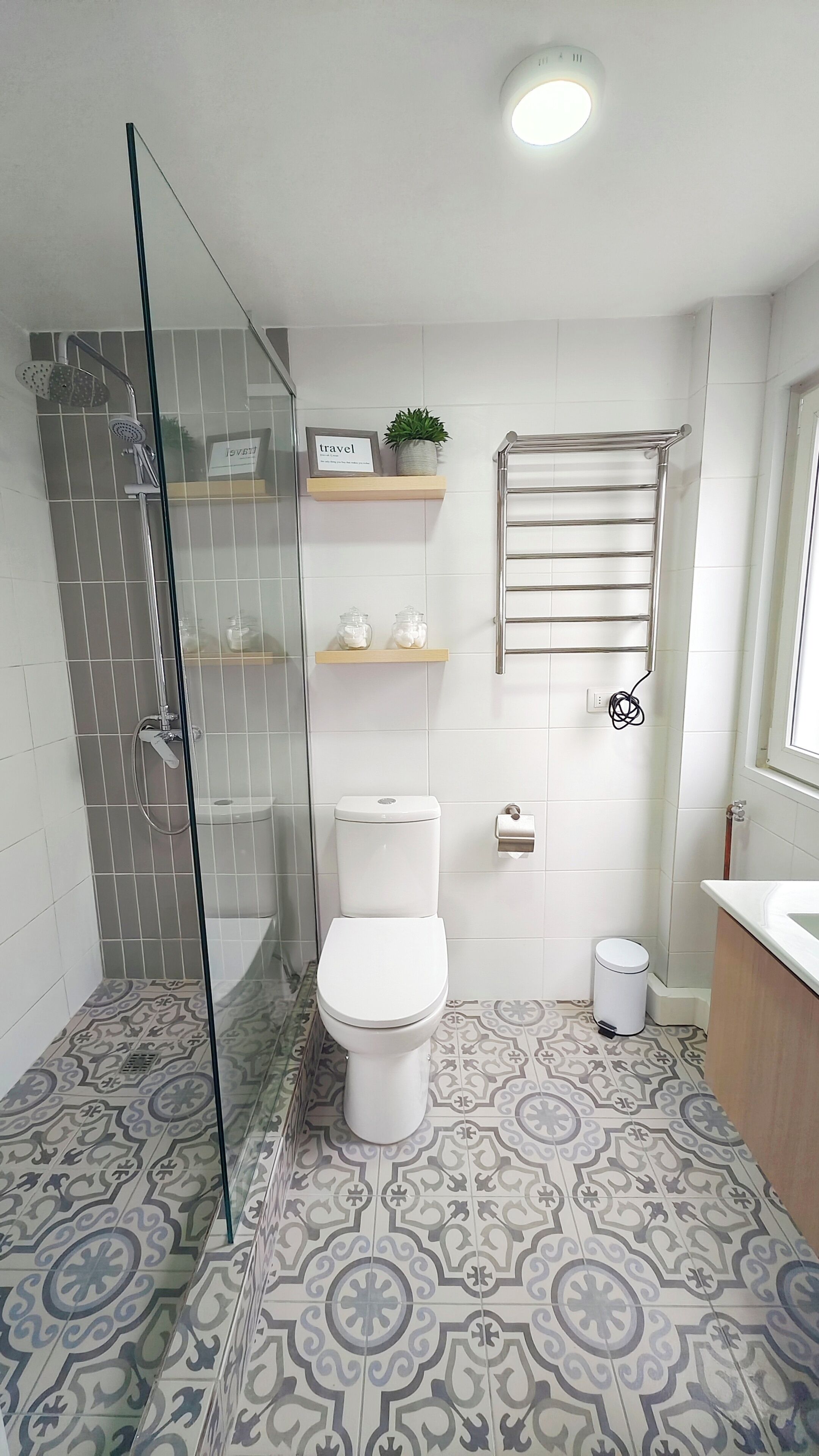 A bathroom with a shower, toilet, and sink.