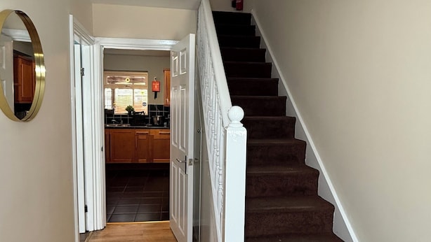 A staircase with a white handrail leading to a second-floor landing. - Cosy 5-bed house in Swanley (Swanley)