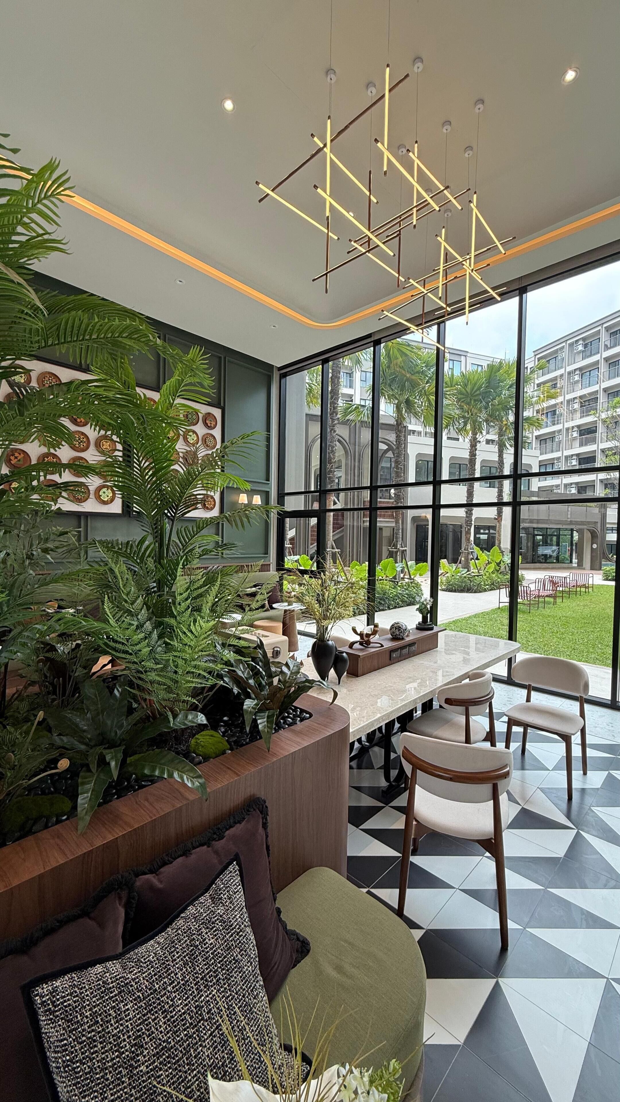 A modern interior with a dining area, large windows, and indoor plants.