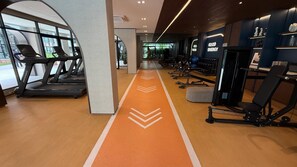 A gym with treadmills, a cardio track, and weightlifting equipment. - 1BR Pool & WiFi⁠ @ 10 min Patong Beach & Central (Tambon Kathu)