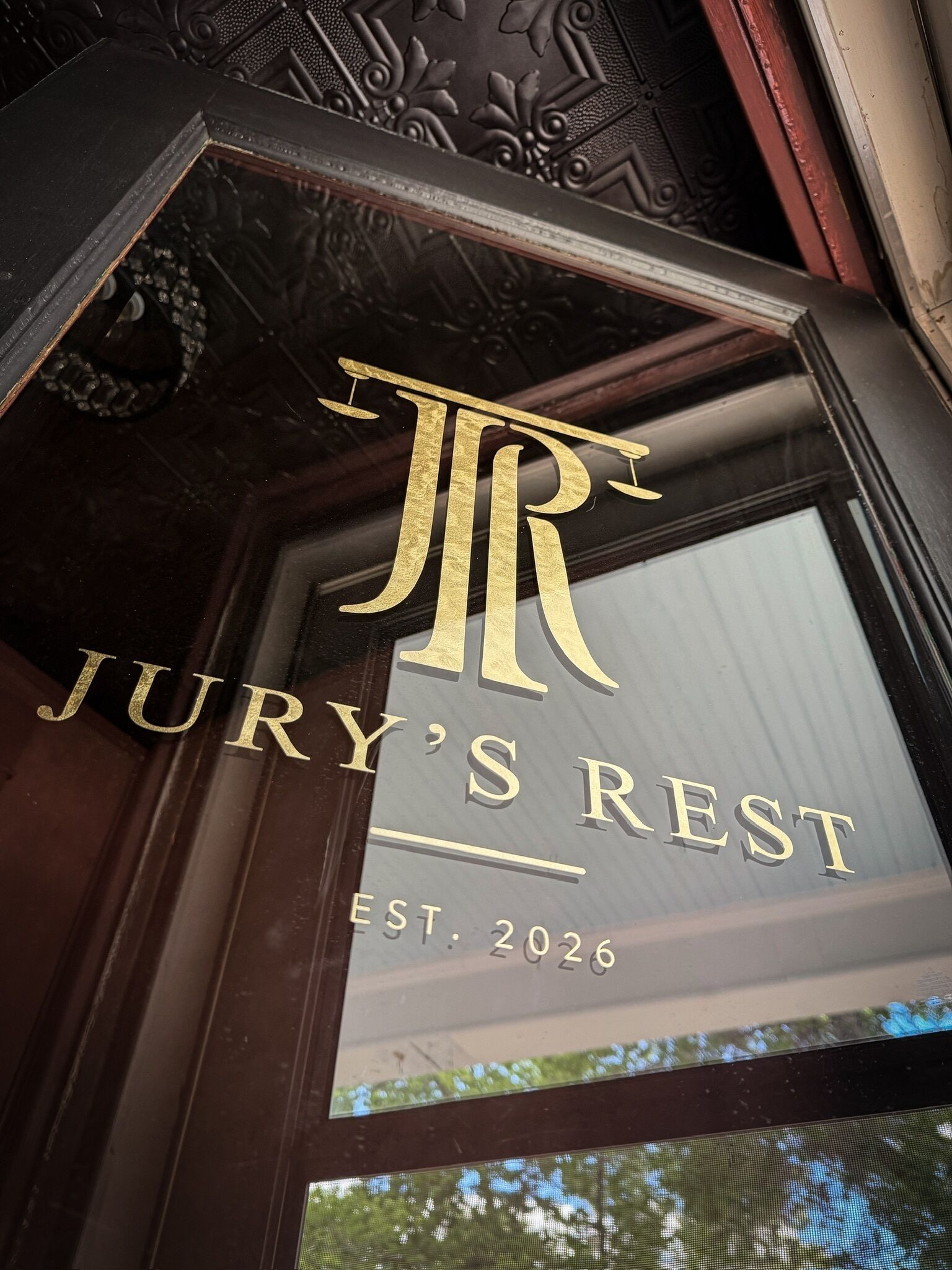 A hotel sign with the name 'JURY'S REST' and the establishment year 'EST. 2026'.